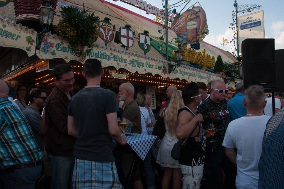 Party goers in front of a funfair stall