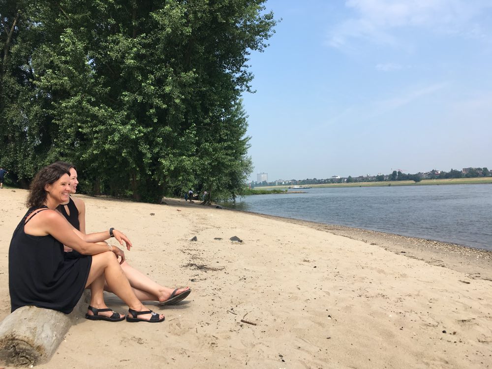 Sandy beach, water and 2 women