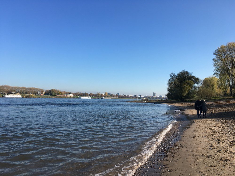 River, beach and couple walking