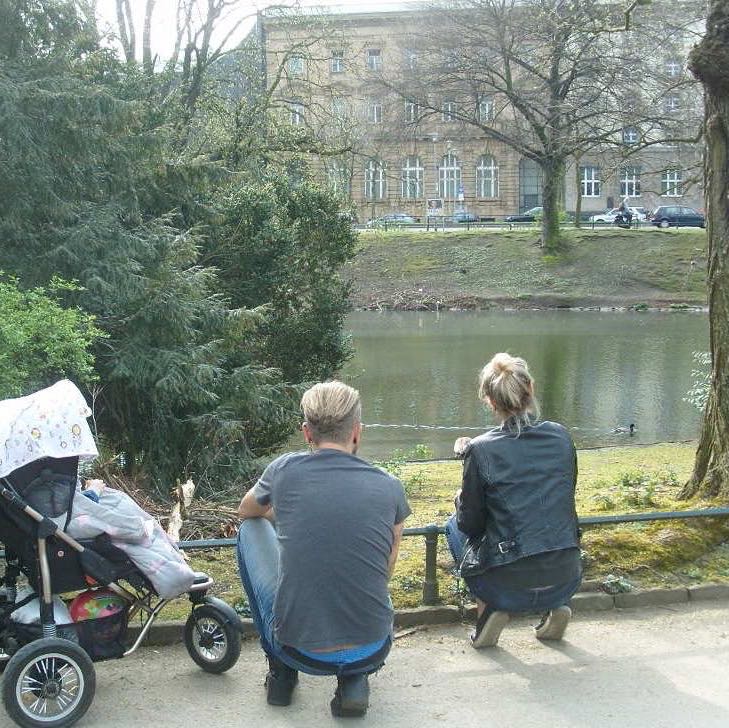 Couple with pram in park
