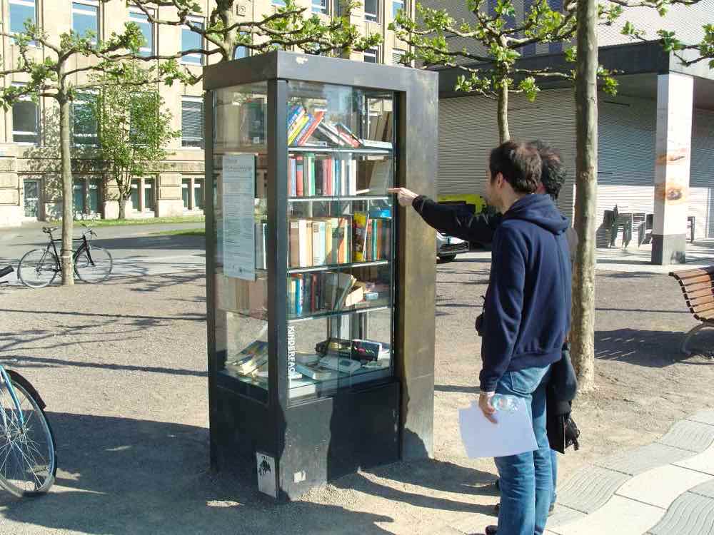 Books in glass cabinet outdoors