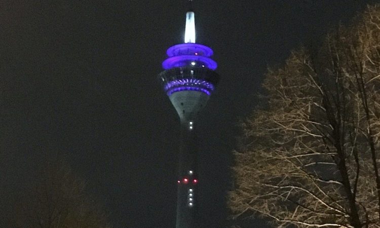 Tower with digital clock by night