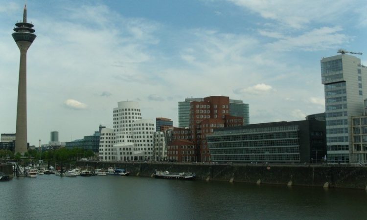 View over water with harbour buildings and tower