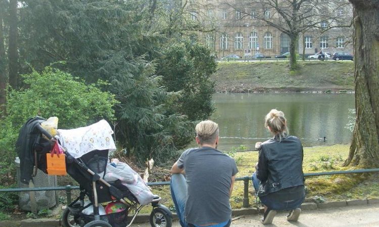 Couple with pram in park