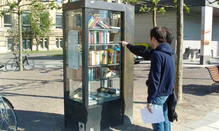 Books in glass cabinet outdoors